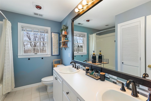 bathroom featuring a sink, visible vents, baseboards, and toilet