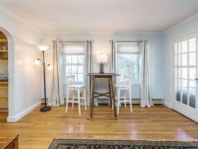 interior space with wood finished floors, arched walkways, and a healthy amount of sunlight