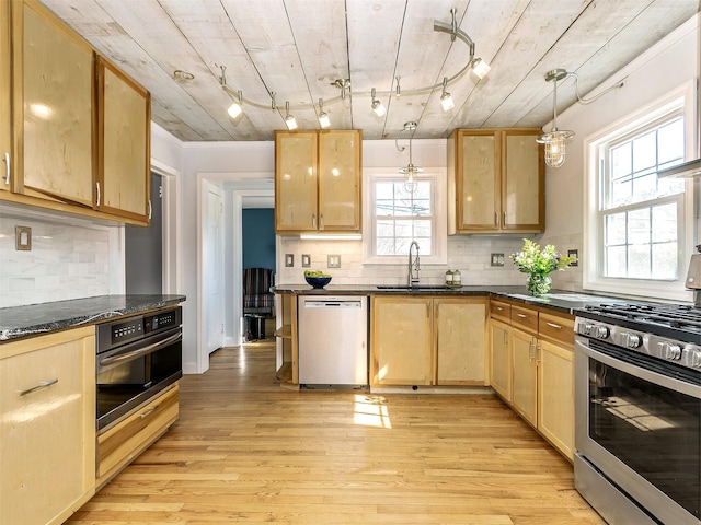 kitchen featuring a sink, light wood-style floors, light brown cabinetry, and stainless steel appliances