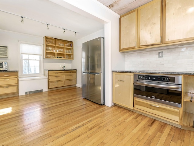 kitchen with visible vents, dark countertops, stainless steel appliances, light wood-style floors, and crown molding