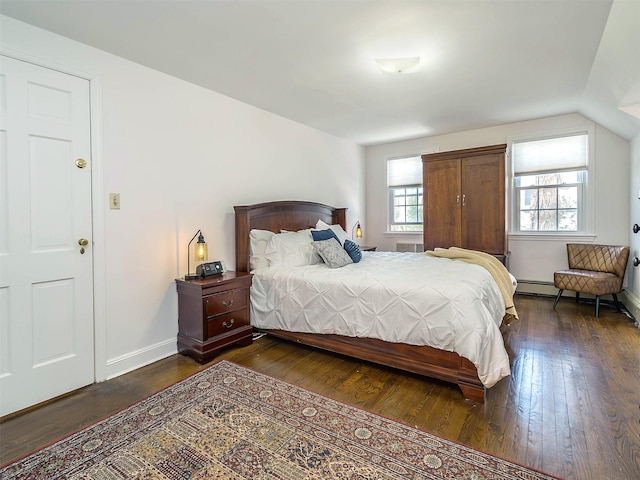 bedroom with dark wood-type flooring, baseboards, and vaulted ceiling