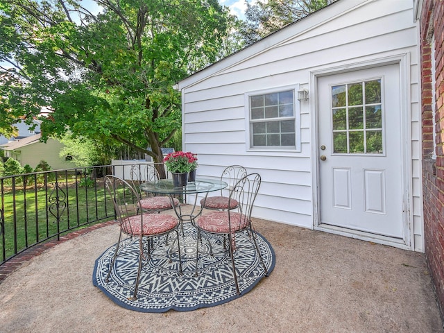 view of patio with outdoor dining space and fence