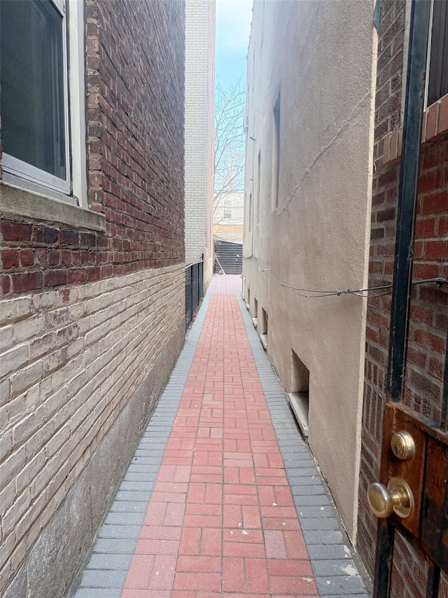 view of side of property with stucco siding and brick siding