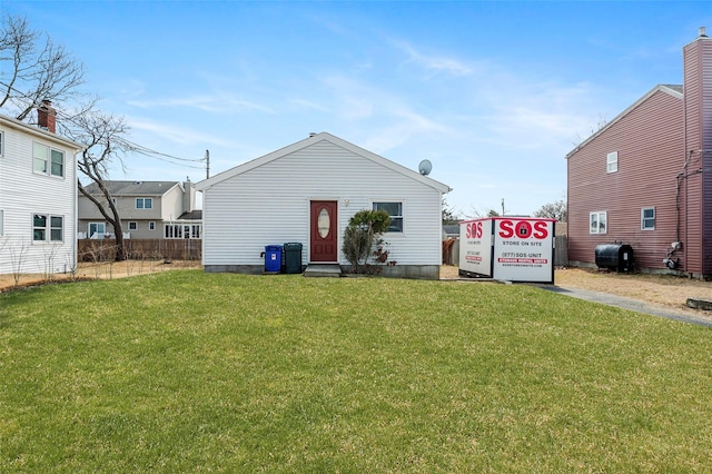 back of property with a lawn and heating fuel