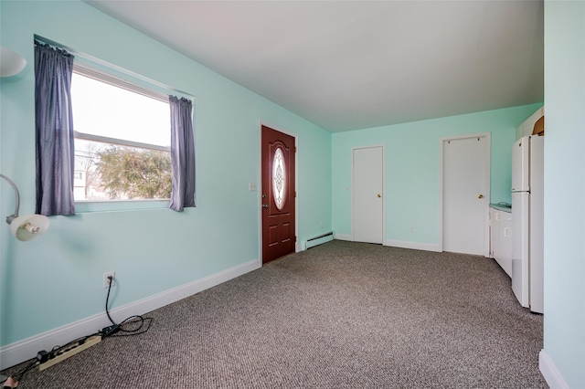 foyer featuring baseboards, dark colored carpet, and a baseboard radiator