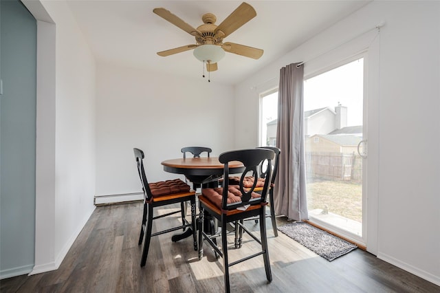 dining area with a baseboard radiator, baseboards, wood finished floors, and a ceiling fan