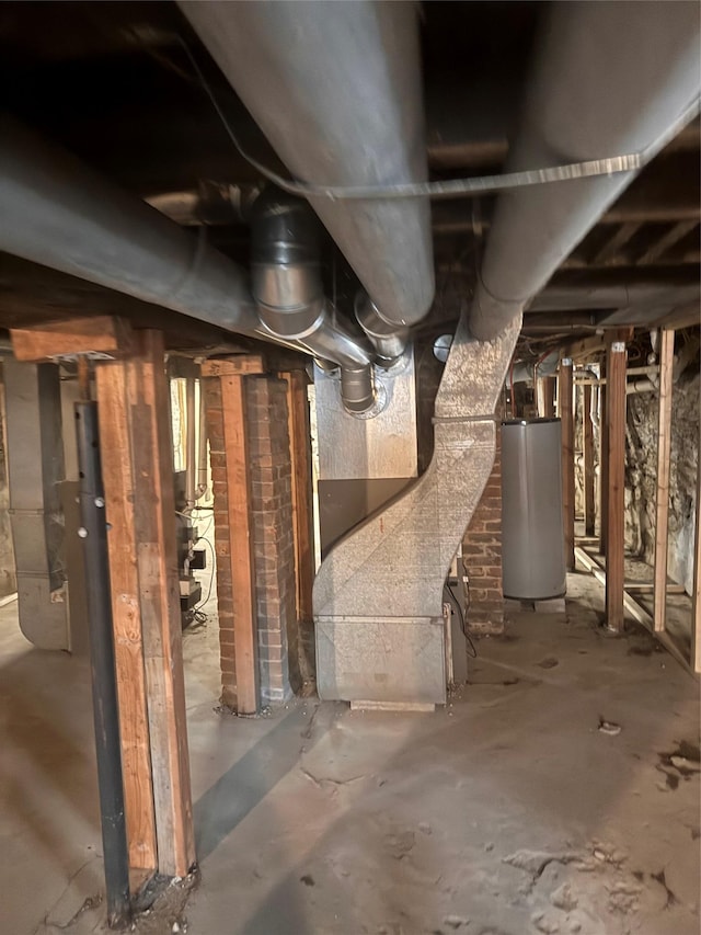 unfinished basement featuring water heater and heating unit