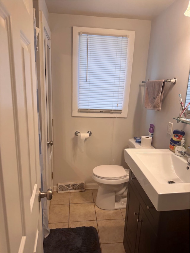 bathroom with visible vents, toilet, vanity, and tile patterned flooring