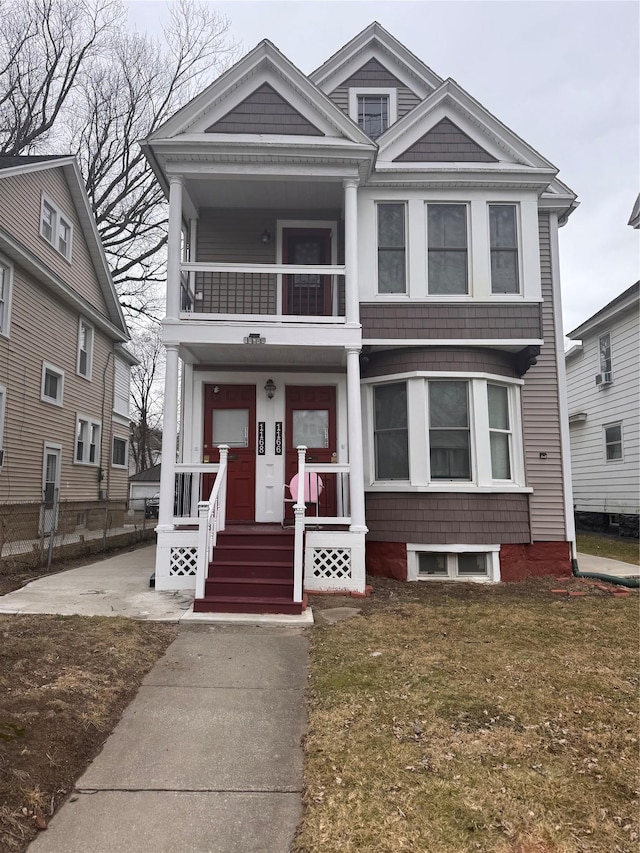 view of front of property featuring a balcony and covered porch