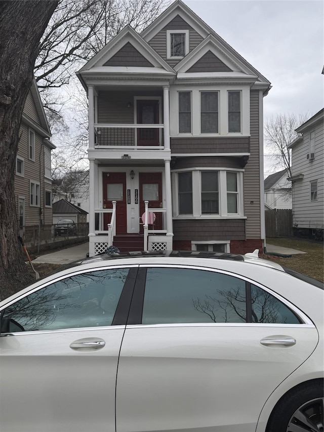 view of front facade with a balcony and fence