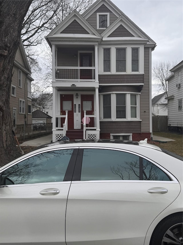 exterior space with a balcony and fence