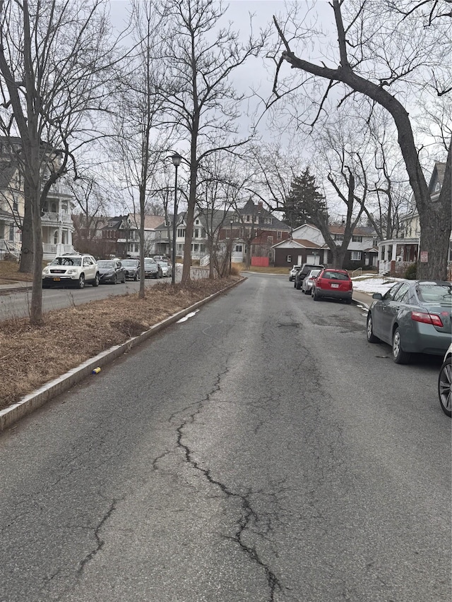 view of street with curbs and a residential view