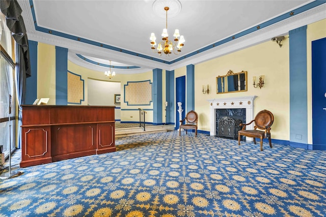 sitting room featuring a tray ceiling, carpet floors, a notable chandelier, and a fireplace