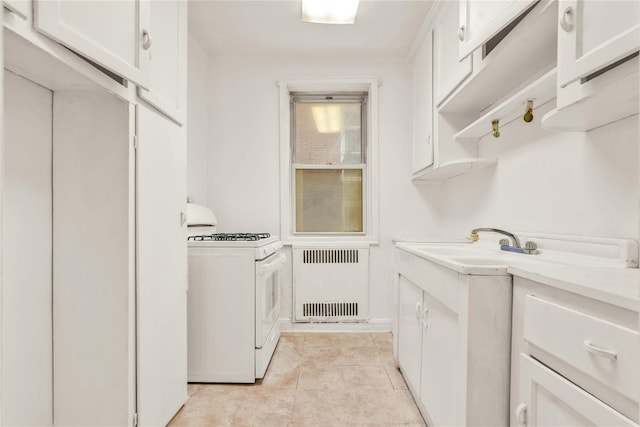 laundry room featuring light tile patterned floors and radiator