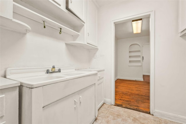 interior space with light tile patterned floors and baseboards