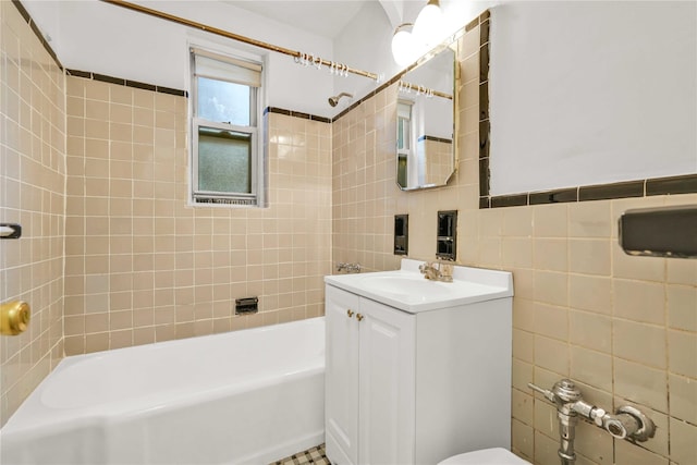 full bath with vanity, tile walls, toilet, and shower / tub combination