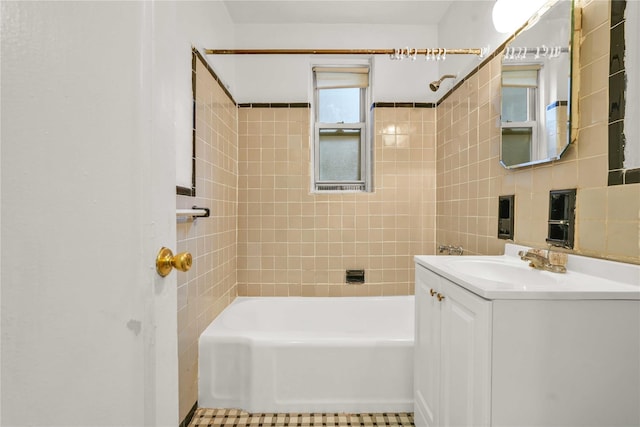 bathroom with vanity, tile walls, tile patterned floors, and shower / washtub combination