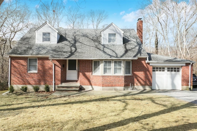 cape cod-style house with brick siding, driveway, an attached garage, and a front lawn