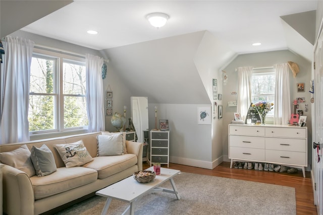 living area with lofted ceiling, recessed lighting, wood finished floors, and baseboards