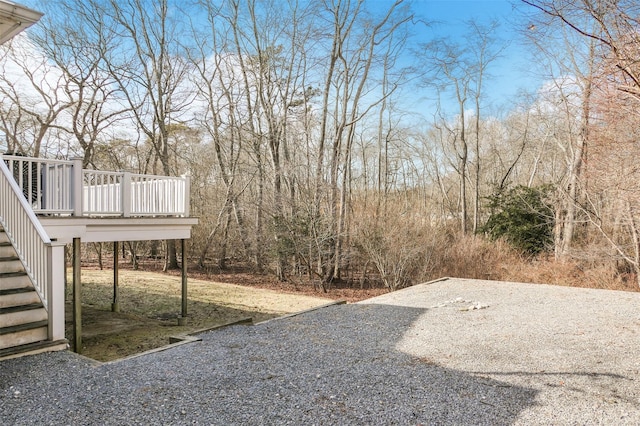 view of yard featuring a wooden deck and stairs