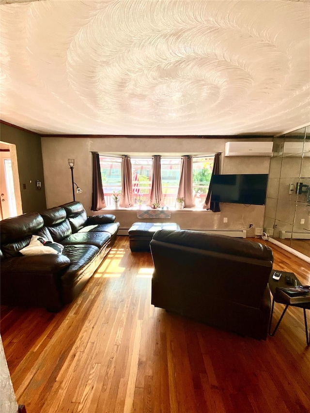 living room featuring a textured ceiling, a wall mounted air conditioner, and wood finished floors