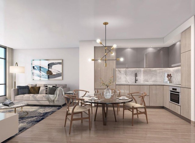 dining area featuring an inviting chandelier and light wood-style floors