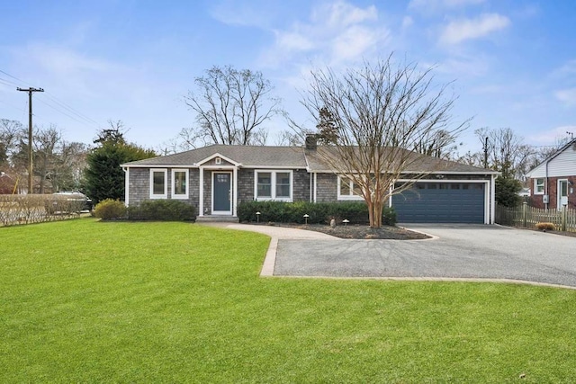 single story home with a front yard, fence, a chimney, a garage, and aphalt driveway