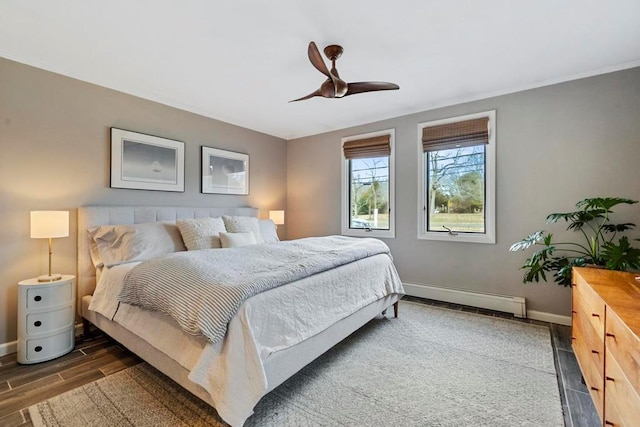 bedroom with ceiling fan, a baseboard radiator, baseboards, and wood finished floors