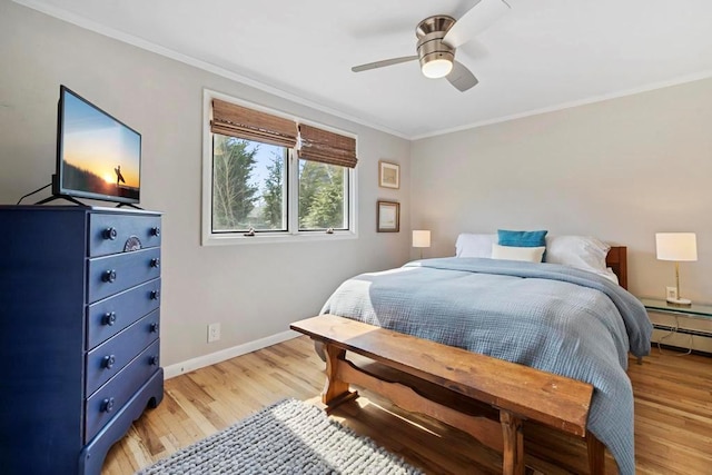 bedroom featuring baseboards, light wood-style flooring, and crown molding