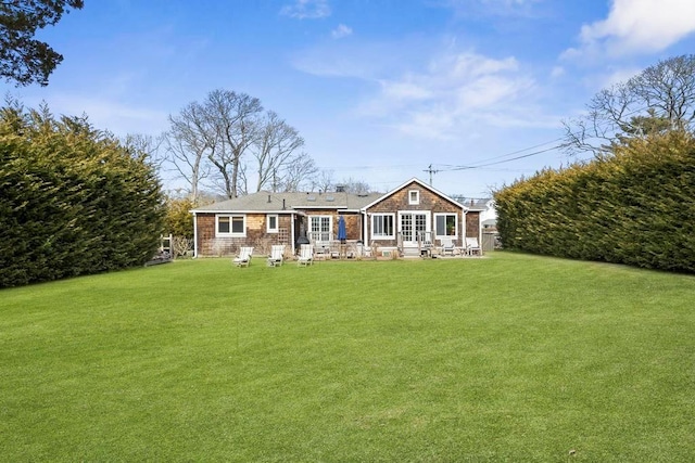 rear view of house with a lawn