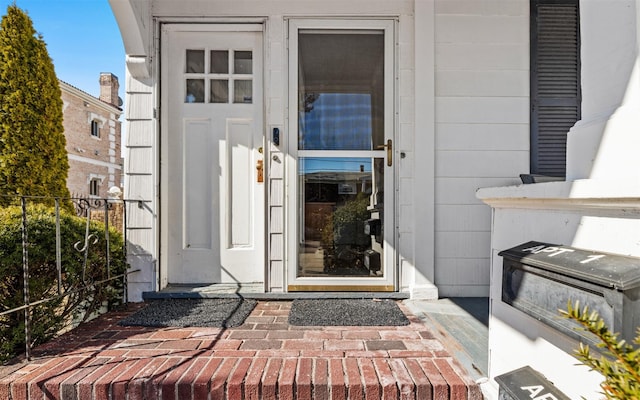 view of exterior entry featuring fence