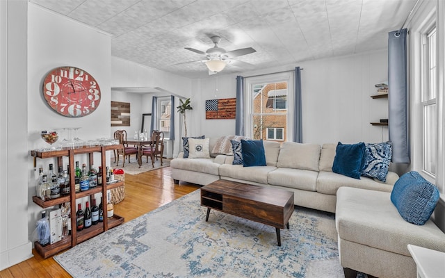 living room with ceiling fan and hardwood / wood-style floors