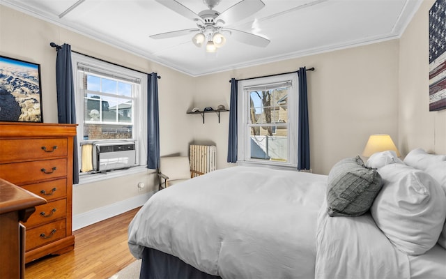 bedroom with crown molding, multiple windows, radiator heating unit, and cooling unit