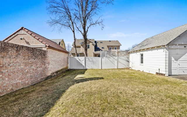 view of yard featuring an outbuilding and fence