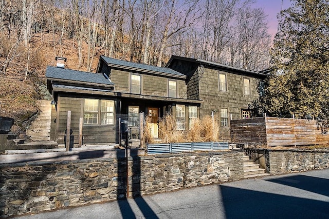 view of front of house featuring a chimney