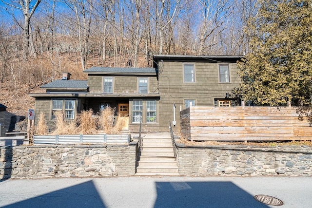 view of front of house with fence and a chimney