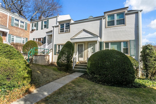 townhome / multi-family property featuring a front lawn