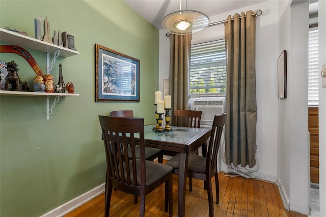 dining space featuring baseboards and hardwood / wood-style floors