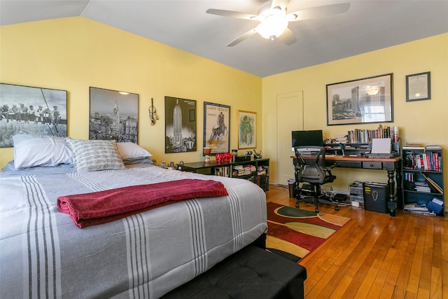 bedroom with ceiling fan, lofted ceiling, and hardwood / wood-style floors