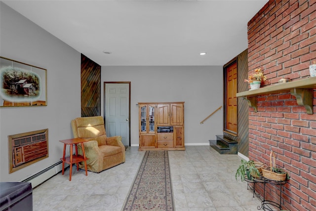 living area featuring baseboards, stairs, a wall unit AC, and a baseboard radiator