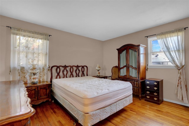 bedroom featuring baseboards and light wood-style floors