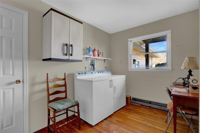 laundry room with laundry area, light wood-type flooring, and washer and clothes dryer