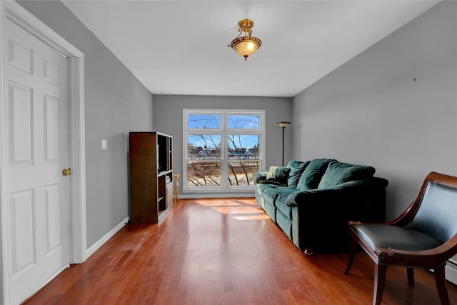 sitting room featuring wood finished floors, baseboards, and baseboard heating