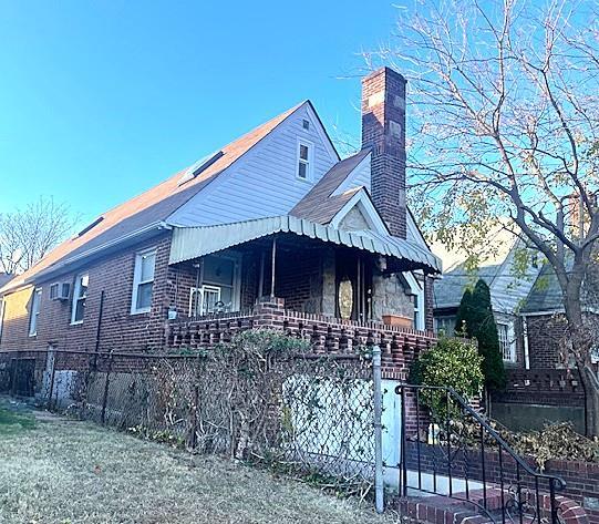 view of front of property featuring a fenced front yard and a chimney