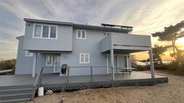 rear view of property featuring a balcony