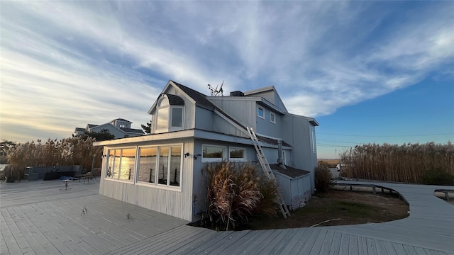 view of side of home featuring outdoor lounge area and a wooden deck