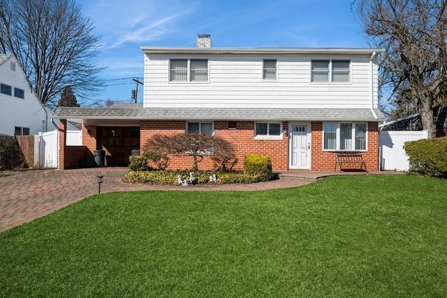 view of front facade featuring a front yard, fence, brick siding, and a chimney