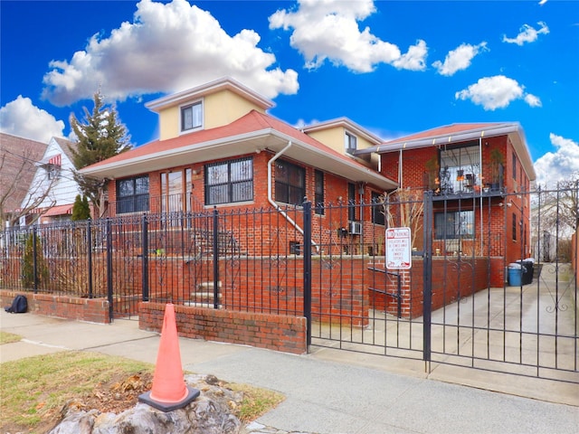 view of front facade featuring a gate, brick siding, and a fenced front yard