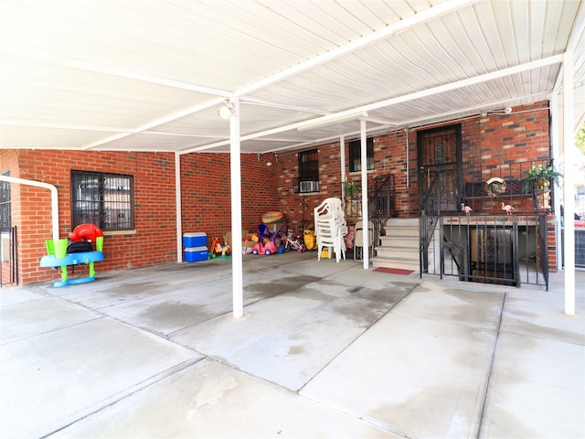 view of patio featuring an attached carport and a porch