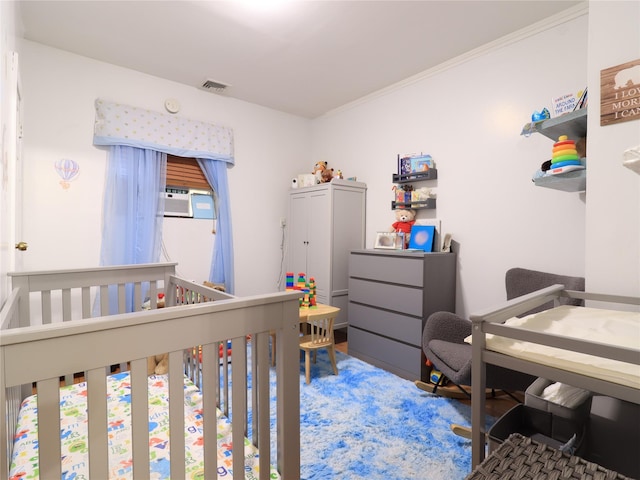 bedroom with crown molding, cooling unit, and visible vents